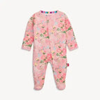 A baby footed sleeper in light pink with a colorful floral print, featuring long sleeves, an asymmetrical snap closure, and a striped collar.