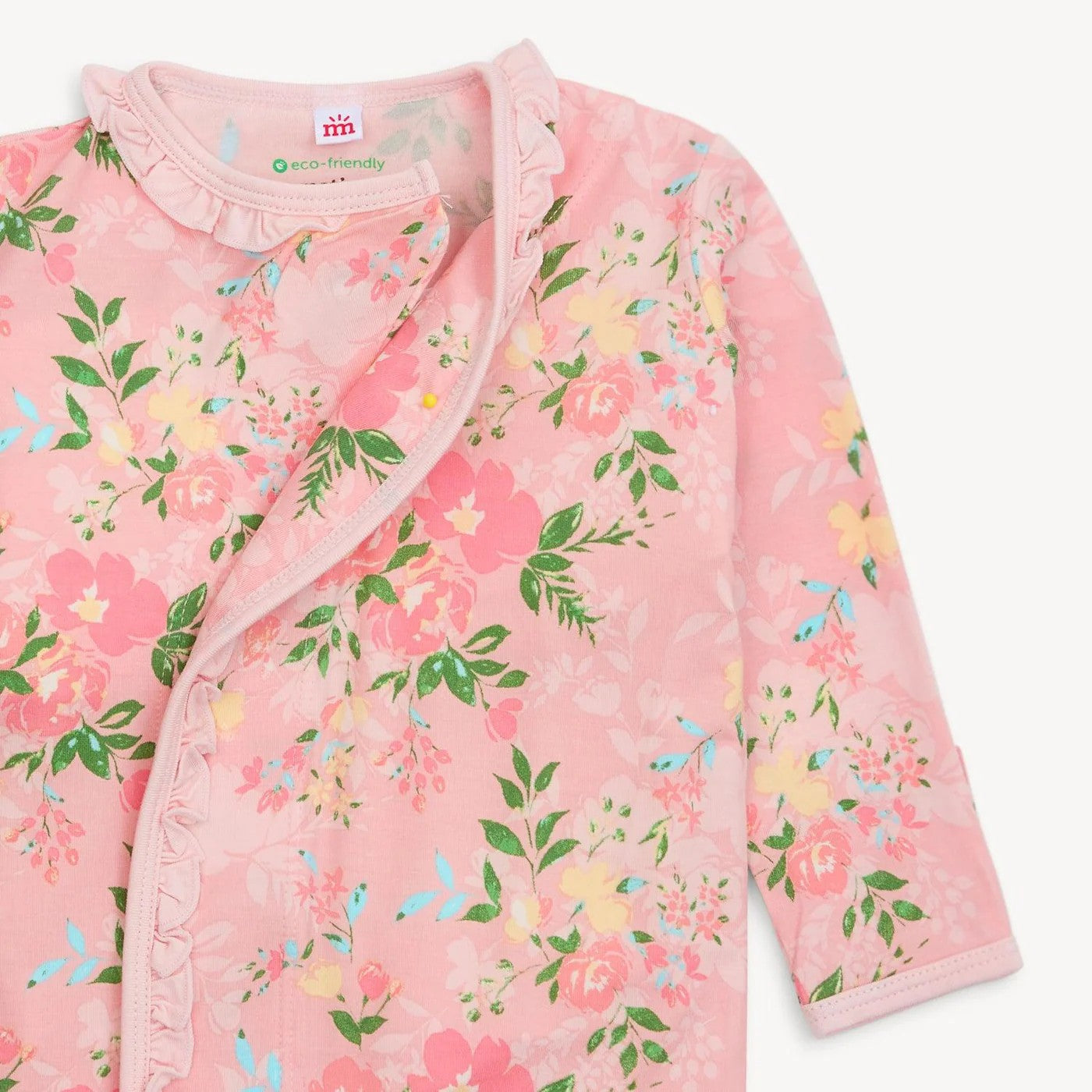 Pink floral baby romper with ruffled collar on a light pink background