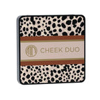 Compact makeup palette with a stylish spotted design on the case, featuring the Merle Norman Cosmetics - Backstage Cheek Duo (Limited-Edition) text in gold lettering.