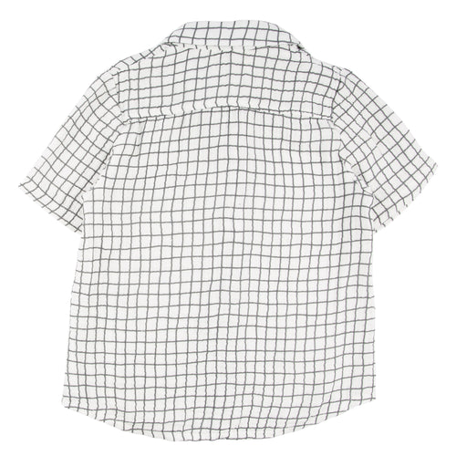 Back view of a short-sleeve children’s button-up shirt in white with a black grid pattern, featuring the Miki Miette - Badminton Jerry Button Up Shirt design from a curated children’s boutique.