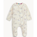 A baby footed sleeper in cream-colored fabric with a print of gray elephants, yellow stars, and small trees, featuring a colorful striped collar.