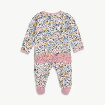 A baby long-sleeve footed sleeper with a pink floral print, featuring a solid pink ruffle trim across the middle and pink cuffs and toe.