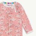 Pink floral patterned pajams with 'eco-friendly' label on a white background.