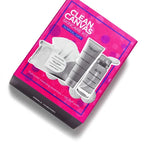 Bright pink box containing the Clean Canvas Skincare Kit (Limited-Edition) with clear bottles and containers designed for normal to dry skin, displayed with cleansing puffs.