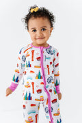 Toddler wearing Convertible Footies - Bamboo - Pink Chicago, featuring colorful Chicago-themed illustrations on a soft, breathable fabric designed for comfort and style.
