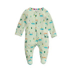 A baby long-sleeve footed sleeper in a light sage green color, featuring an all-over cartoon golf course print with golf carts, trees, and players. The sleeper has a snap-button closure at the collar and is shown against a plain white background.