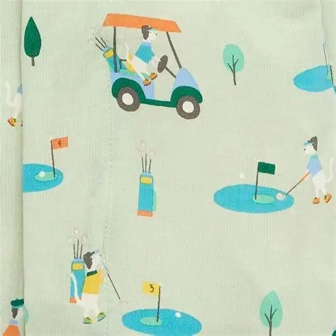 A close-up of a light sage green fabric with a repeating cartoon golf course print. The pattern features stylized golf carts, players, golf balls, flags, and trees in muted teal, blue, yellow, and orange colors.