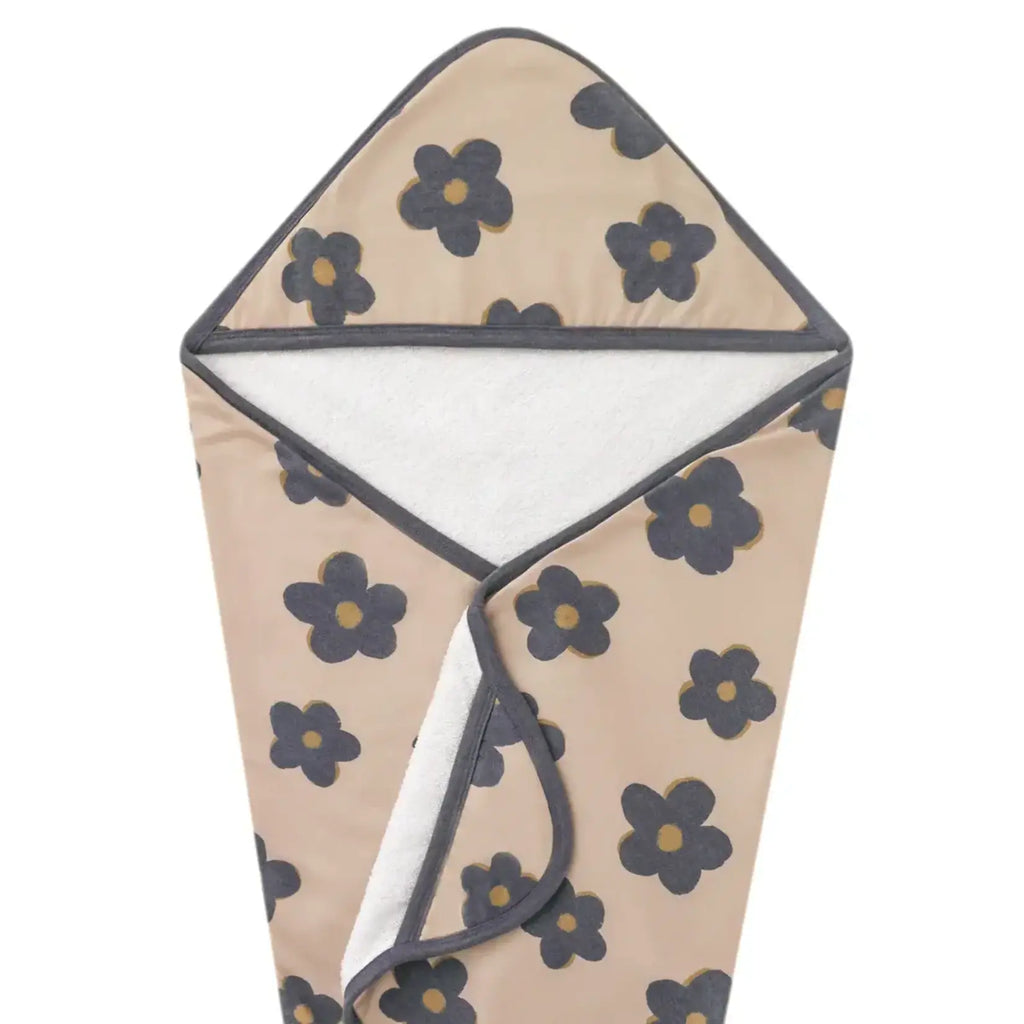A hooded baby wrap or swaddle blanket with a beige background, dark gray floral pattern, and a white fleece lining, shown against a plain white background.