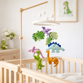 Mobile - Felt Baby - Jurassic Dinosaur hanging above a wooden crib with colorful felt dinosaur and leaf shapes, creating a cozy and playful nursery ambiance.