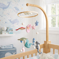 Mobile - Felt Baby - Sea Life hanging above a wooden crib with felt sea creatures and stars in calming pastel colors, designed for a cozy nursery with soft neutral aesthetics.