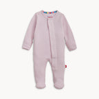 A baby footed sleeper in light pink waffle knit fabric, featuring a snap-button front closure and a small red tag near the lower leg, shown against a plain off-white background.
