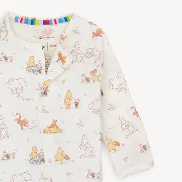 Baby onesie with Winnie the Pooh pattern on a white background