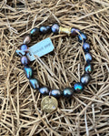 BeYoutiful Vibes - Stretch Bracelet ~ Peacock Pearl Gemstone featuring iridescent dark pearls with a gold charm engraved "be you," styled on natural straw for a cozy, elegant look.