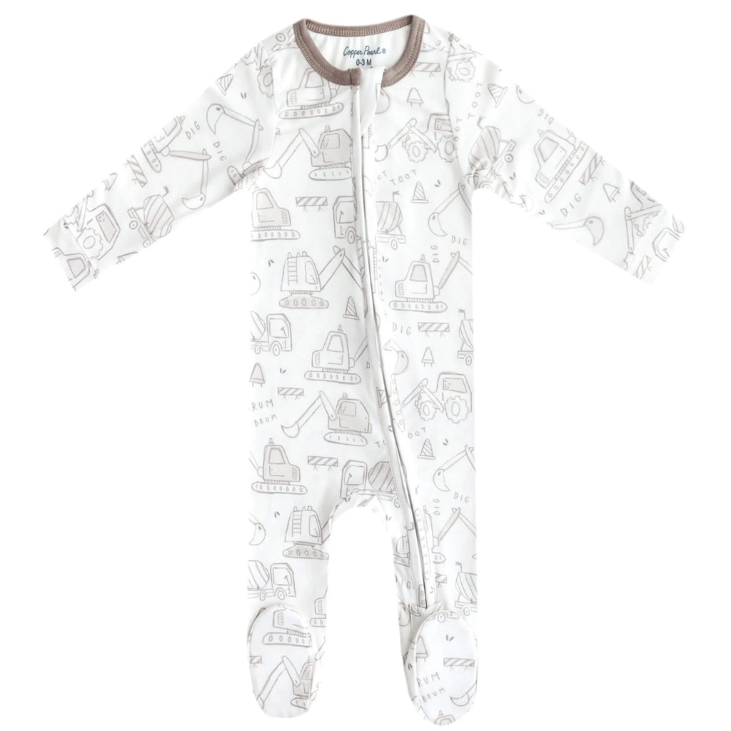 A baby long-sleeve footed sleeper in white with a light gray construction vehicle print, featuring a brown collar.