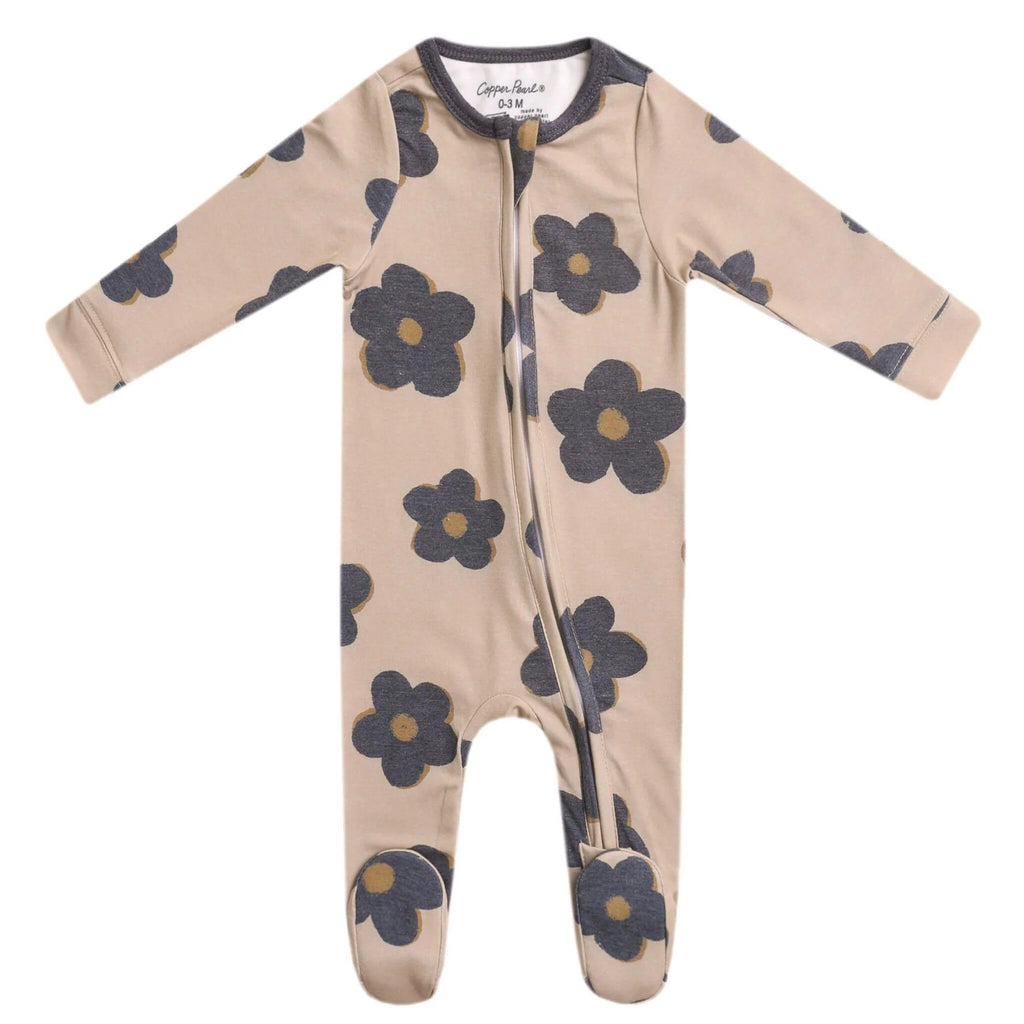 Zip-up beige footie pajama lying flat on a white background with flowers in grey color. 