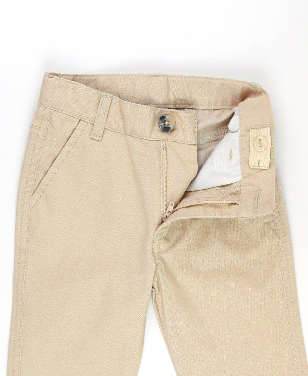 Close-up of RuffleButts + RuggedButts - Boys Khaki Stretch Chino Pants: Off-White showing waistband, button, and zipper details, highlighting soft neutral fabric ideal for stylish kids clothing.