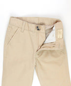 Close-up of RuffleButts + RuggedButts - Boys Khaki Stretch Chino Pants: Off-White showing waistband, button, and zipper details, highlighting soft neutral fabric ideal for stylish kids clothing.
