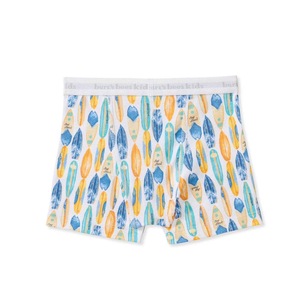 A pair of kids' boxer briefs, featuring a white background with a colorful pattern of surfboards in blue, yellow, and orange.