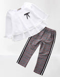 Fennco Styles - Ruffle Layered Blouse & Grey Tartan Pant 2pcs Girl Outfit featuring a white blouse with layered ruffles and a black bow detail paired with grey tartan pants with black and white side stripes, perfect for stylish kids clothing from a curated children’s boutique.