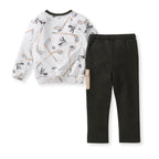 Burt's Bees Baby - Hockey Season Sweatshirt & Pants Set featuring a white sweatshirt with a hockey stick and puck pattern paired with solid black pants, perfect for cozy baby essentials from a curated children’s boutique.