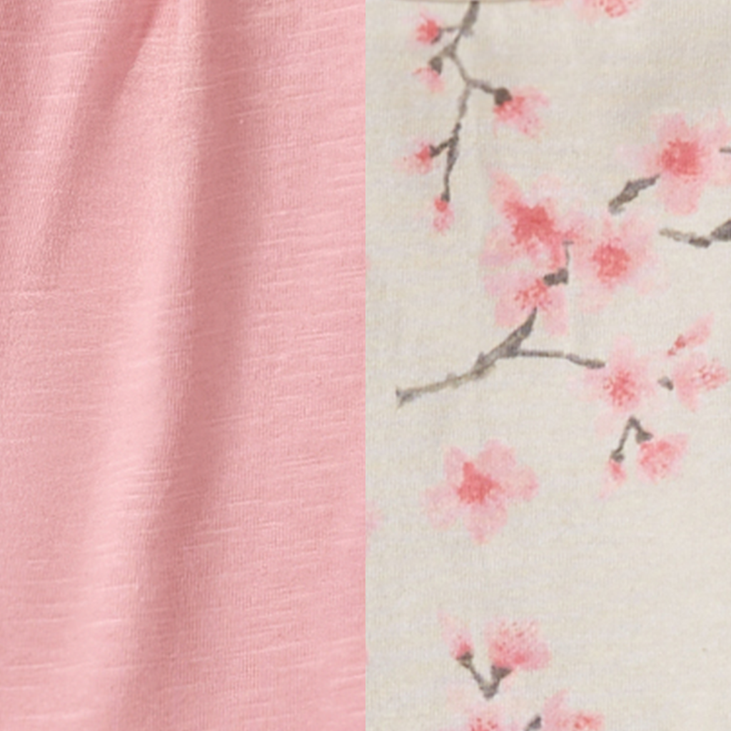 Close-up of soft pink slub fabric and delicate cherry blossom floral print on cream background from the Burt's Bees Baby - Slub Tunic & Cherry Blossoms Pants Set, perfect for stylish kids clothing.