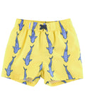 RuffleButts + RuggedButts - Boys Jawsome Swim Trunks in bright yellow with a playful blue shark pattern, featuring an elastic waistband and drawstring for a comfortable fit.