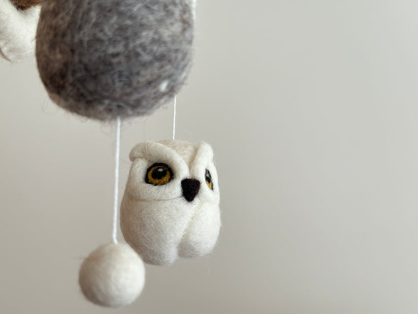 Close-up of wool felt owl hanging from a baby mobile in soft neutral tones, part of Mobile - Felt Baby - Owl from a curated children’s boutique focused on cozy baby accessories.