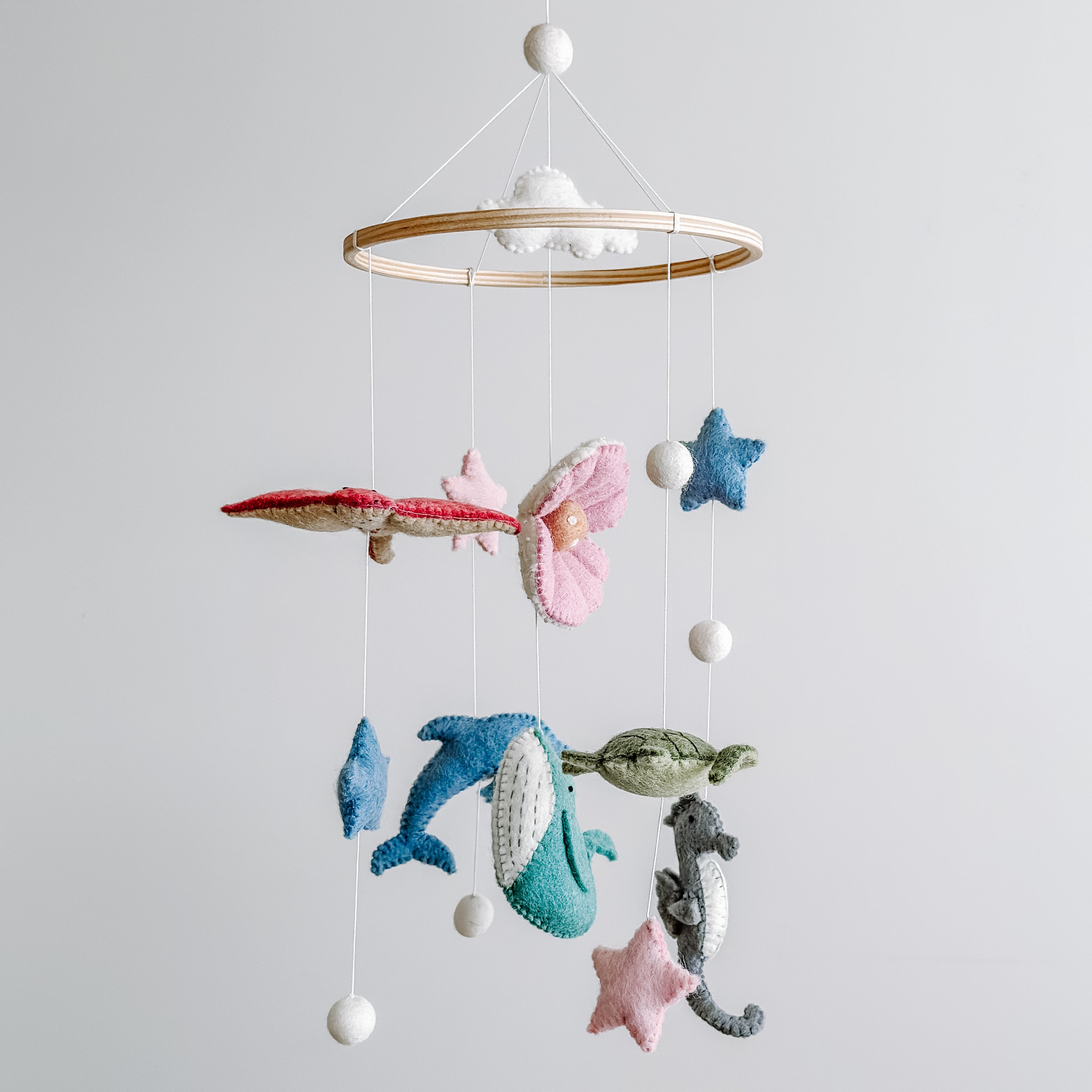 Mobile - Felt Baby - Sea Life featuring hanging handmade felt sea creatures and shapes in soft pastel colors, crafted for nursery decoration and sensory stimulation.