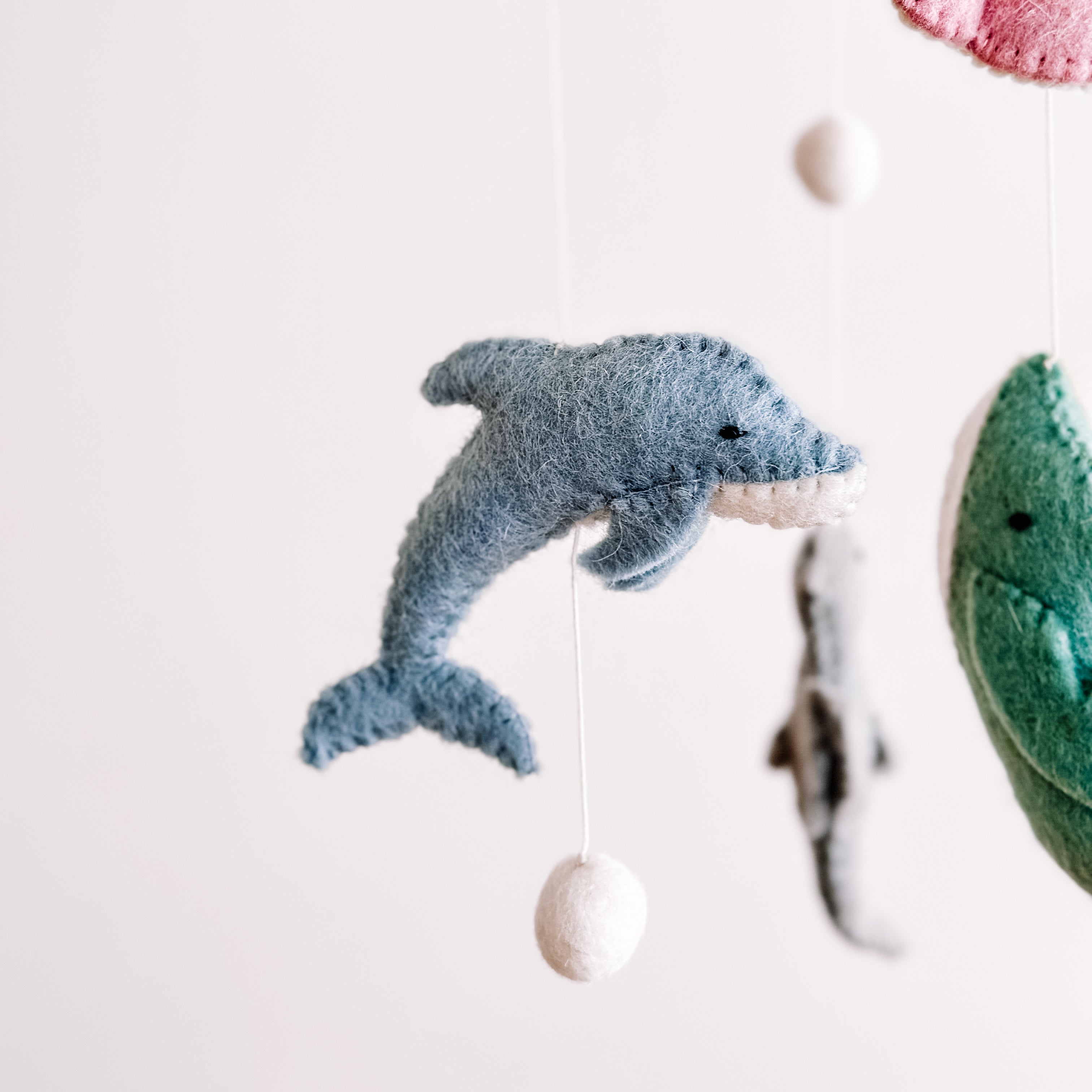 Soft felt dolphin from the Mobile - Felt Baby - Sea Life, a charming baby accessory designed with soothing colors and cozy, breathable fabrics for a modern children’s boutique.