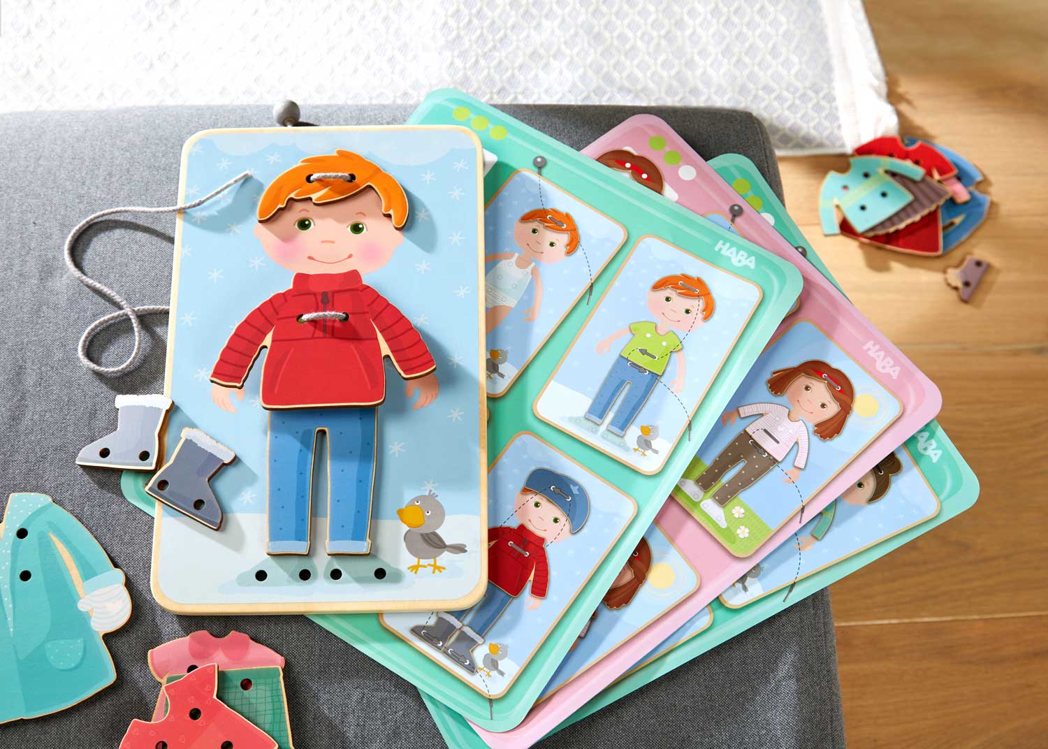 Dress Me Threading & Lacing Game featuring wooden characters and clothing pieces designed for imaginative play and fine motor skills development in children.