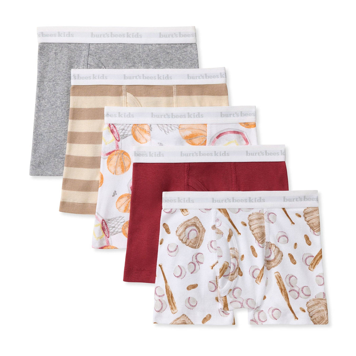 A 5-pack of kids' boxer briefs, arranged in a staggered fan layout on a white background. The set includes solid gray, beige and tan striped, white with orange basketball illustrations, solid red and white with brown baseball illustrations.