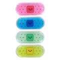 Four colorful gel packs with smiling faces in pink, blue, green, and yellow, designed as soothing accessories for kids, featured in the Oopsie - Bandz Oopsie Packs collection.