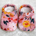 Soft baby shoes with a pink floral pattern featuring yellow and orange blooms, designed for comfort and style by CLAMFEET - ISABEL, perfect for stylish kids clothing.