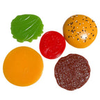 Set of colorful plastic toy food pieces on a white background