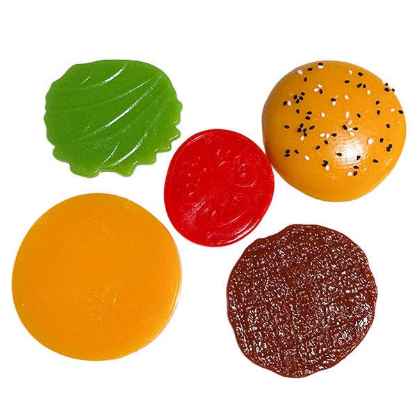 Set of colorful plastic toy food pieces on a white background