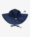 Navy blue RuffleButts + RuggedButts - Kids Sun Protective Hat with wide brim and adjustable chin ties, designed for stylish sun protection in a curated children’s boutique.