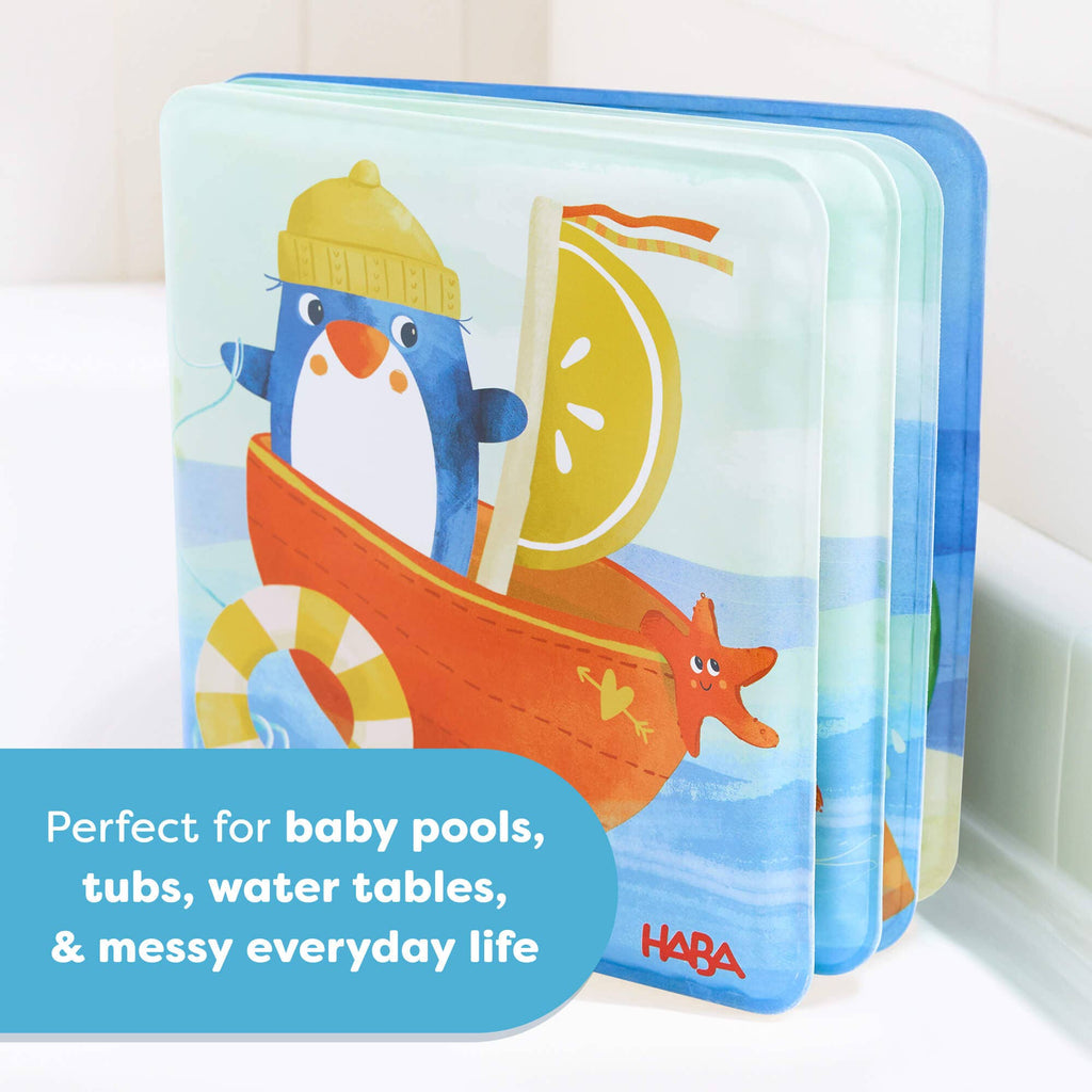 Penguin Bath Book with Squeaker featuring a playful penguin sailing a boat, designed as a waterproof, durable bath book ideal for sensory play and water activities for babies.