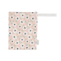 Itzy Ritzy - Travel Happens™ Medium Wet Bags: Playful Petals with a soft pink background and white floral pattern, designed for stylish kids and mom life essentials.