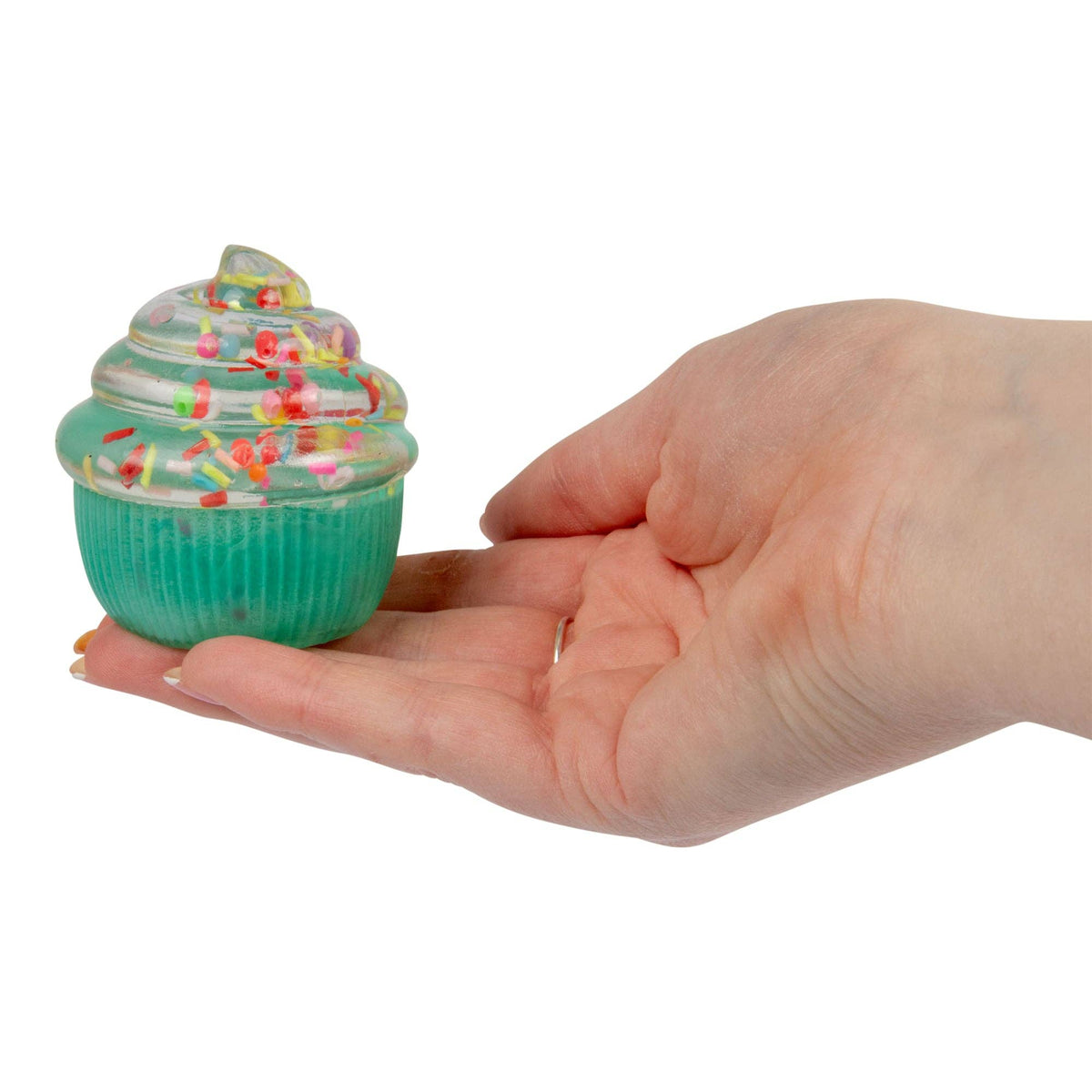 Hand holding a small green cupcake-shaped object with colorful sprinkles on a white background
