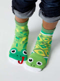 Child wearing green Pals Socks - Frog & Turtle Mismatched Non-Slip Kids Socks with playful animal designs, perfect for stylish kids clothing and cozy essentials from a curated children’s boutique.