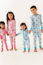 Four children wearing colorful pajamas on a white background