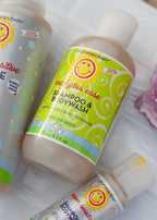 Bottle of California Baby - Eucalyptus Ease™ Shampoo & Bodywash with bright green and yellow packaging, surrounded by other baby care products on a soft white surface.