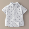Fennco Styles - White Sun Boy Cotton Button-Down Shirt featuring a soft white cotton fabric with subtle star pattern, short sleeves, a front pocket, and classic collar for stylish kids clothing.