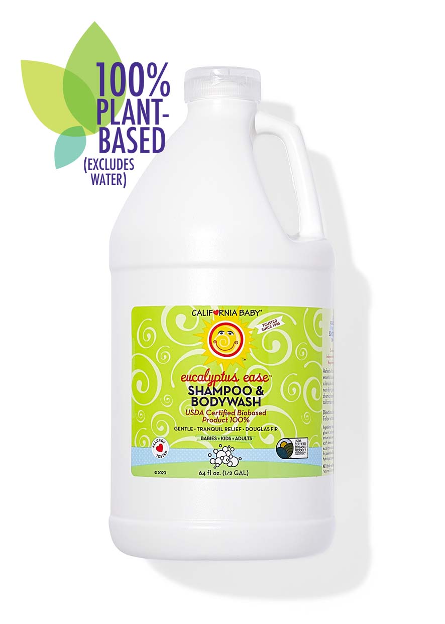 Large white bottle of California Baby - Eucalyptus Ease™ Shampoo & Bodywash with green label featuring a smiling sun, highlighting its 100% plant-based formula ideal for babies, kids, and adults.