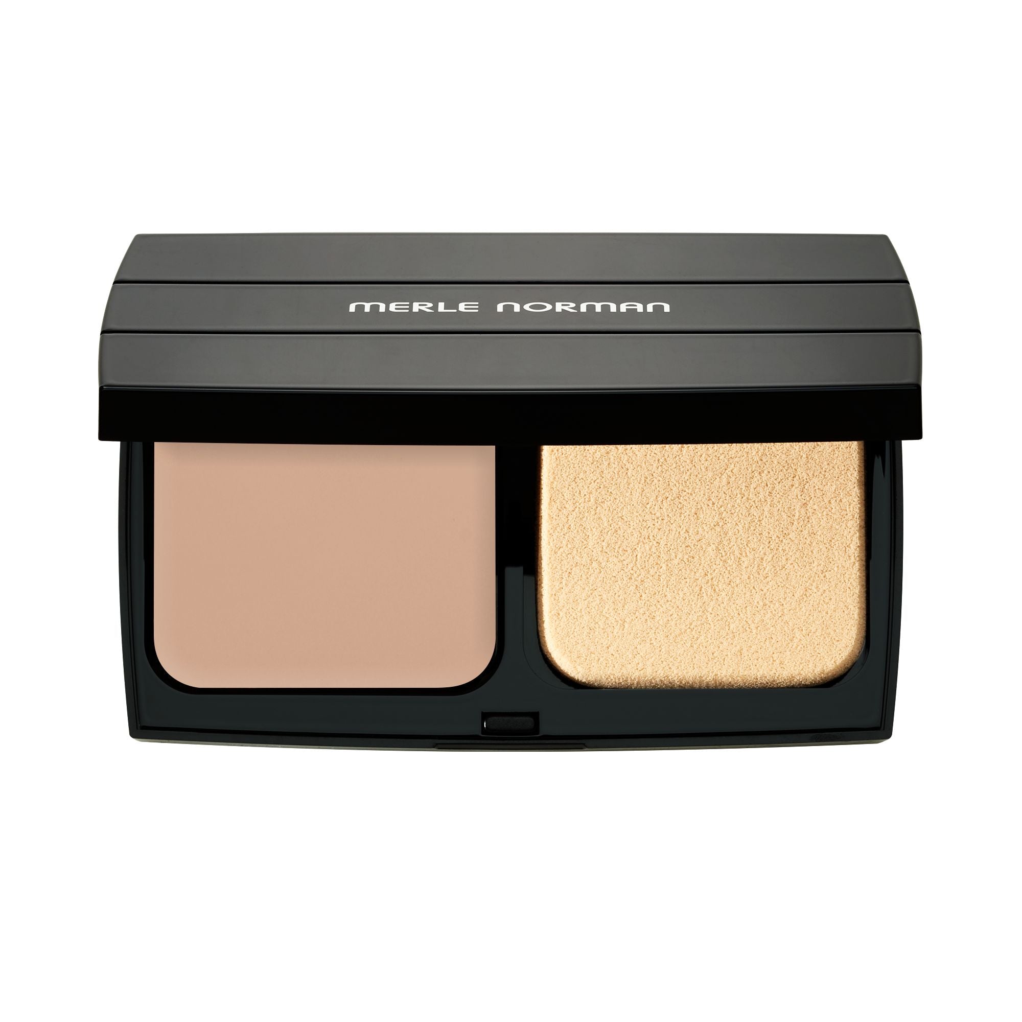 Open compact of Merle Norman Cosmetics - Expert Finish Makeup Broad Spectrum SPF 25 featuring beige pressed powder and light sponge applicator in sleek black case.