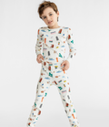 Young child wearing cozy, stylish pajamas with colorful Chicago-themed prints, showcasing SMALLER THINGS - Goodnight, Chicago in soft, breathable fabric perfect for comfortable nights, from a curated children’s boutique focused on stylish essentials for little ones and moms.