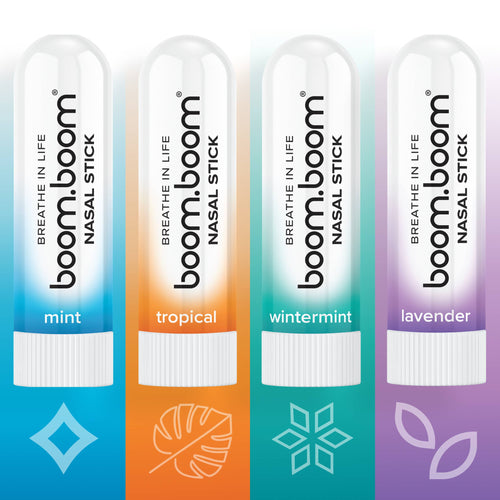 Four colorful BoomBoom - Nasal Stick tubes in mint, tropical, wintermint, and lavender scents, arranged in a row with matching minimalist scent icons below each.