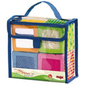 Happy Quartett Baby's 4 Piece Soft Block Set in a clear blue-trimmed carrying case, featuring colorful, textured fabric blocks designed for sensory play and early learning.