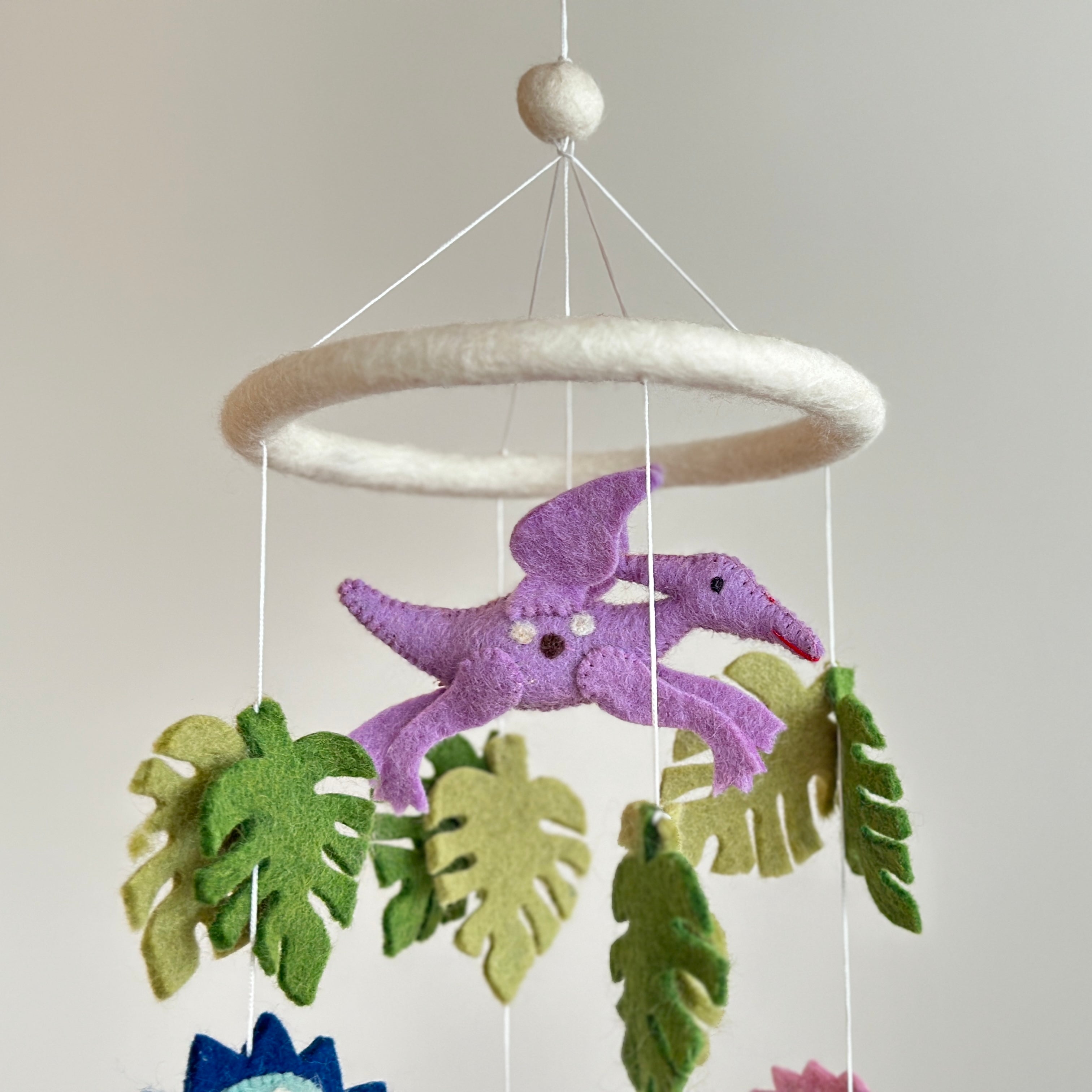 Mobile - Felt Baby - Jurassic Dinosaur hanging soft felt baby mobile featuring a purple dinosaur and green leaves, perfect for a modern baby boutique nursery.