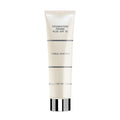 Tube of Merle Norman Cosmetics - Foundation Primer Plus SPF 15 with a sleek, minimal design, perfect for preparing skin with sun protection and smooth application.